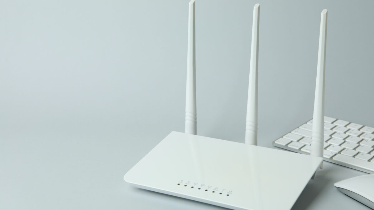 Workplace with Wi - fi router on gray background - Alpha