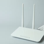 Workplace with Wi - fi router on gray background - Alpha