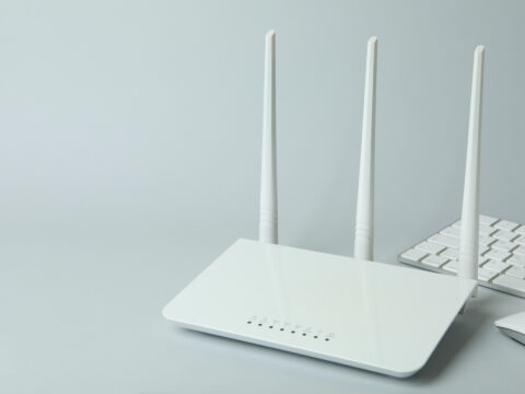 Workplace with Wi - fi router on gray background - Alpha