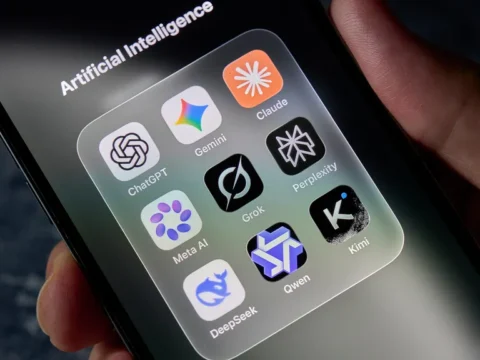 Folder labeled 'Artificial Intelligence' on a smartphone screen showing AI apps like ChatGPT, Gemini, Claude, Perplexity, Meta AI, Grok, Qwen, DeepSeek, and Kimi